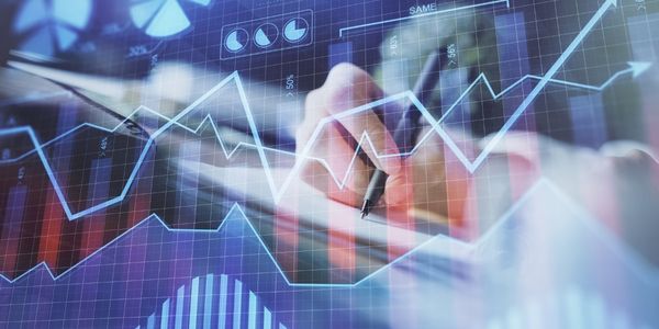 Financial forex graph displayed on hands taking notes background.