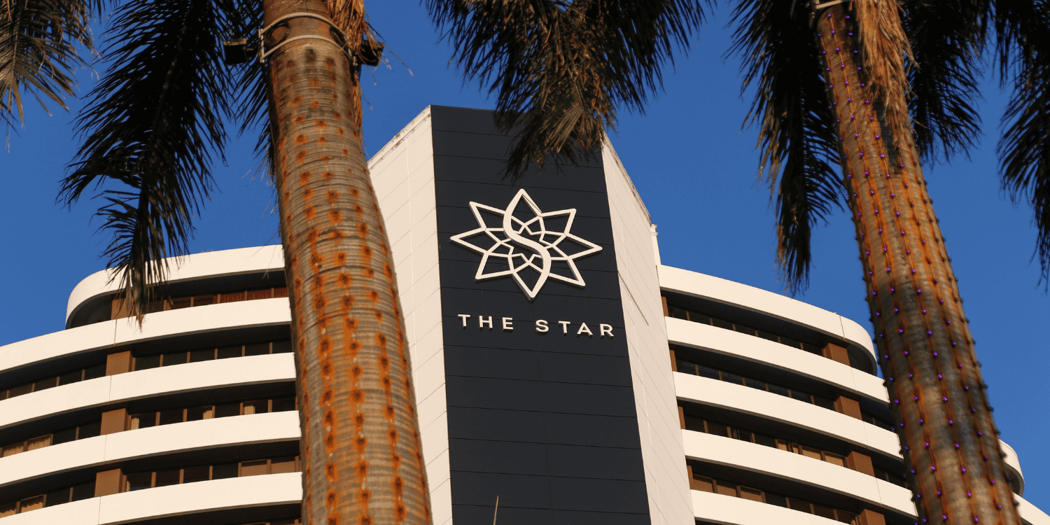 Broadbeach, Queensland, Australia-September 25, 2022: The Star Gold Coast Casino. Oldest building on site called the grand. Main entrance to casino with palm trees and star branding.